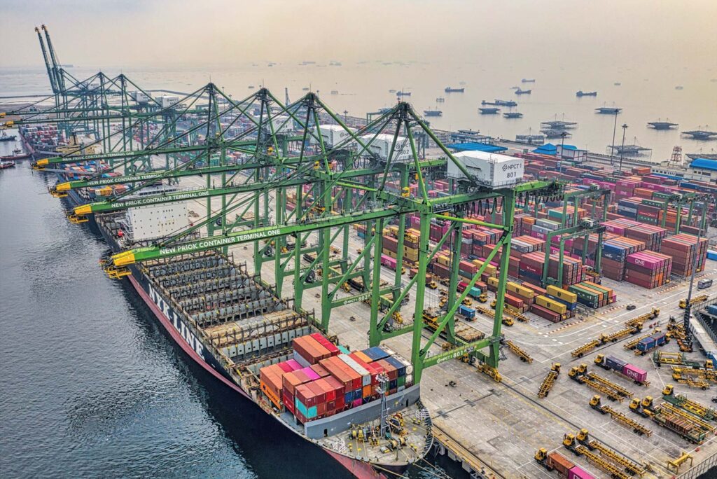 A cargo ship unloading in a Jakarta container port