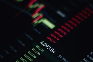 Financial data and graphs on a black screen