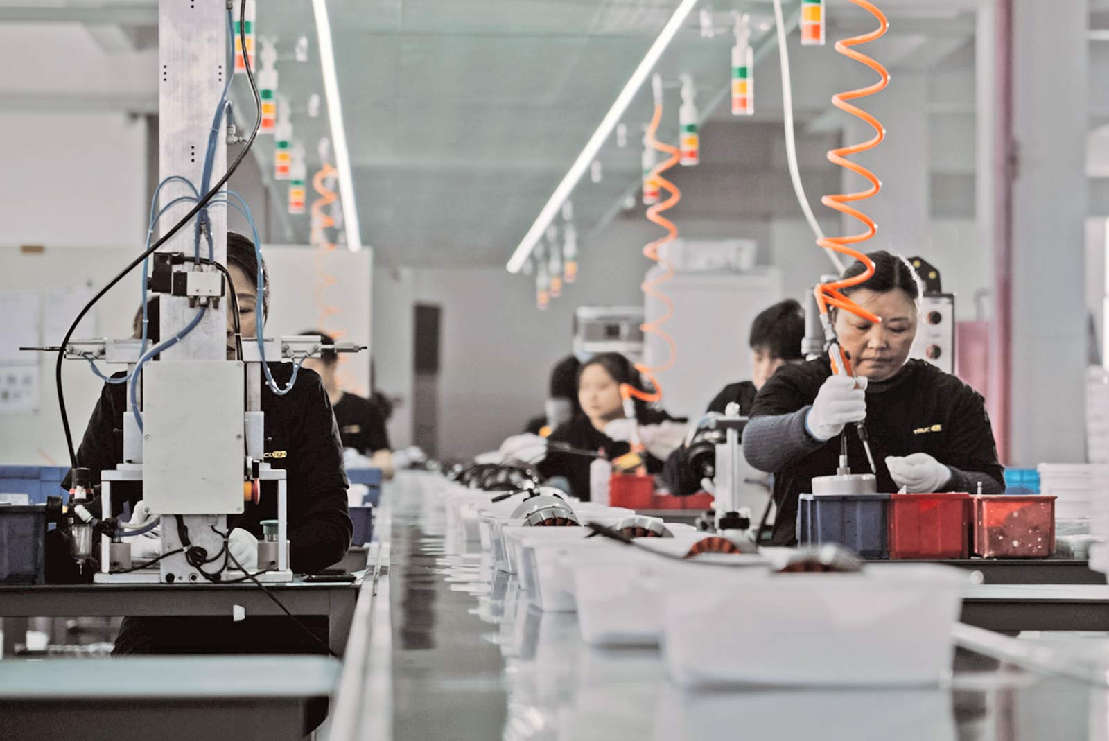Workers on a manufacturing production line